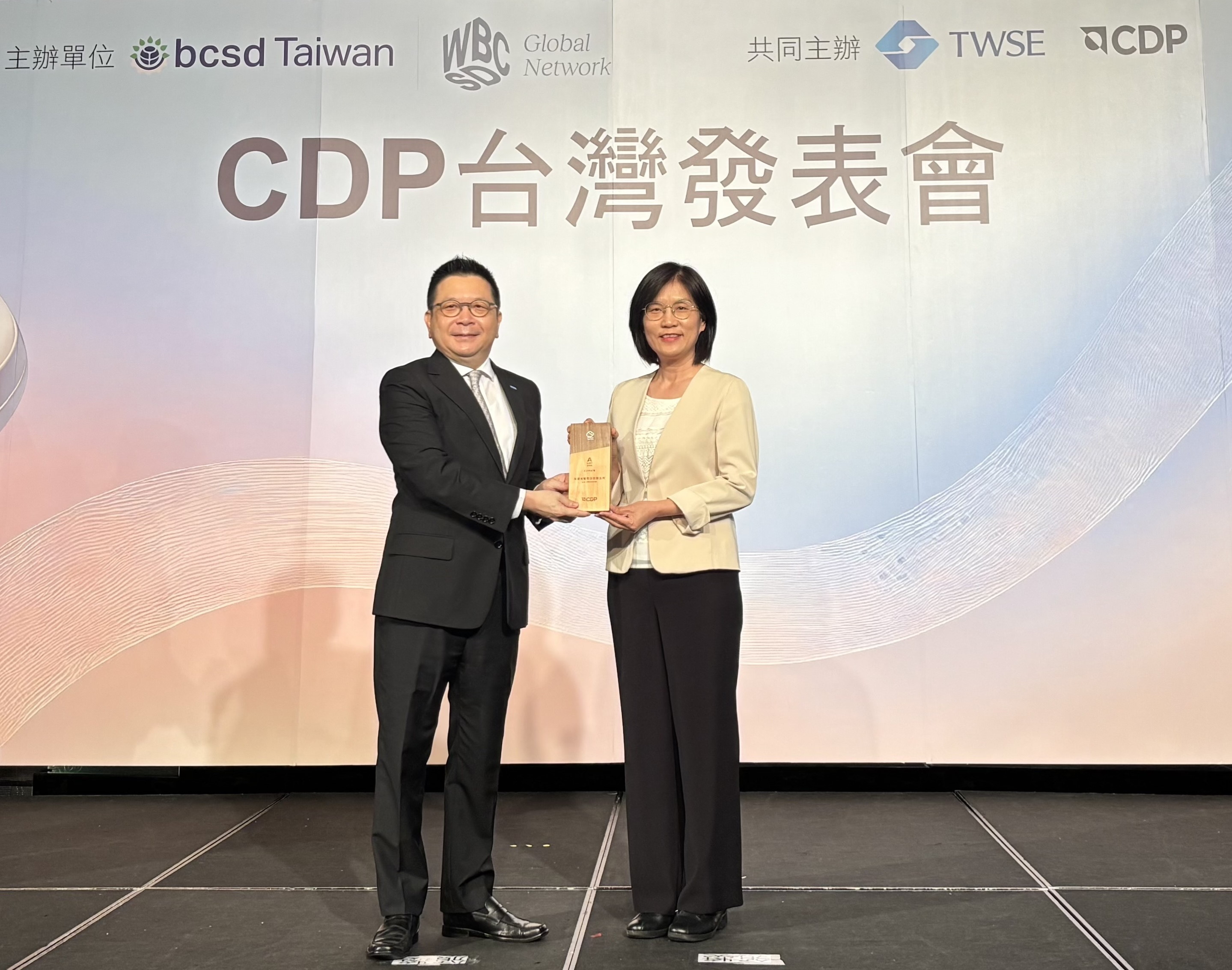 友達永續成果再獲國際評比肯定，獲頒CDP氣候與水資源雙項領導力評級。今由臺灣證券交易所董事長林修銘（左）頒獎，友達光電永續長古秀華（右）代表受獎